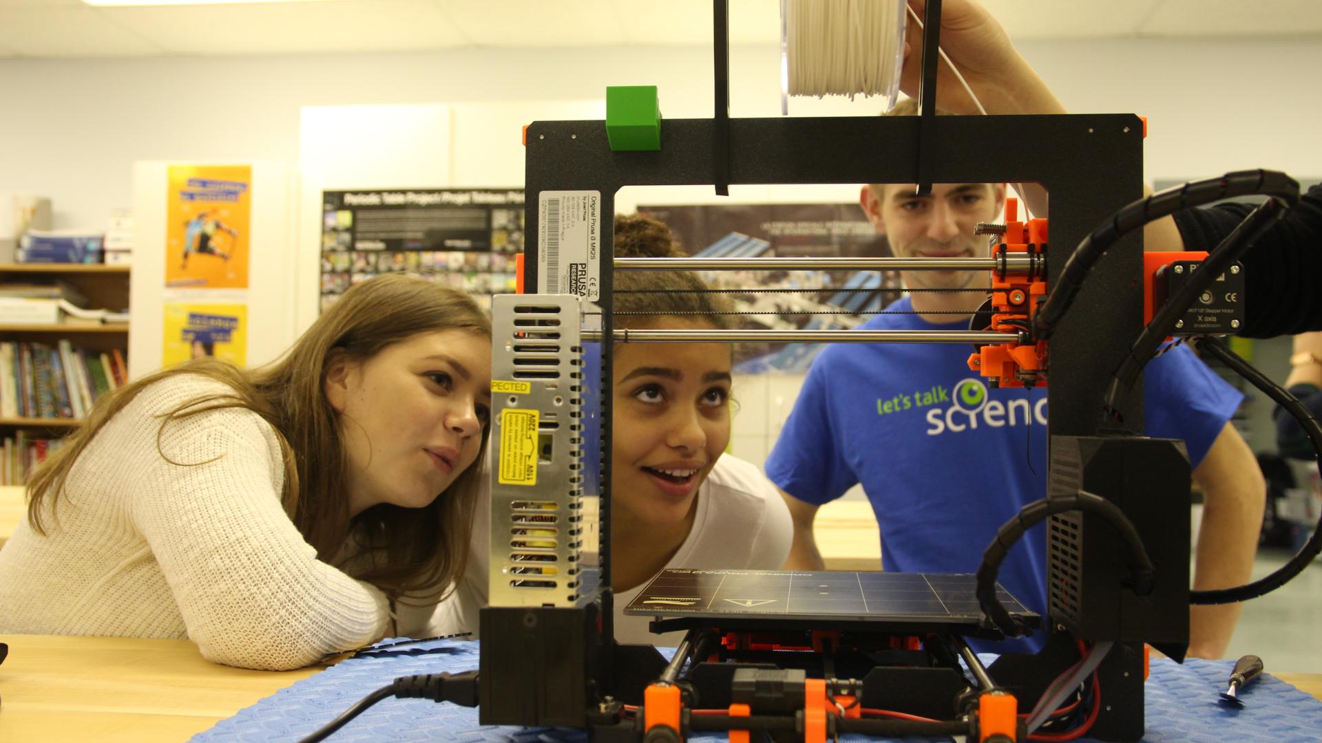 Young students in a technical classroom observing technology