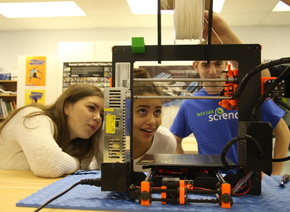 Young students in a technical classroom observing technology